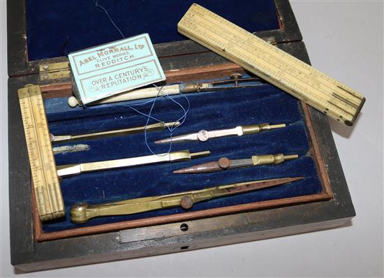 A cased set of draughtsmans instruments and two folding rules